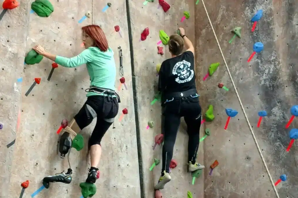 Paula Free doing adaptive rock wall climbing with a friend in Oregon