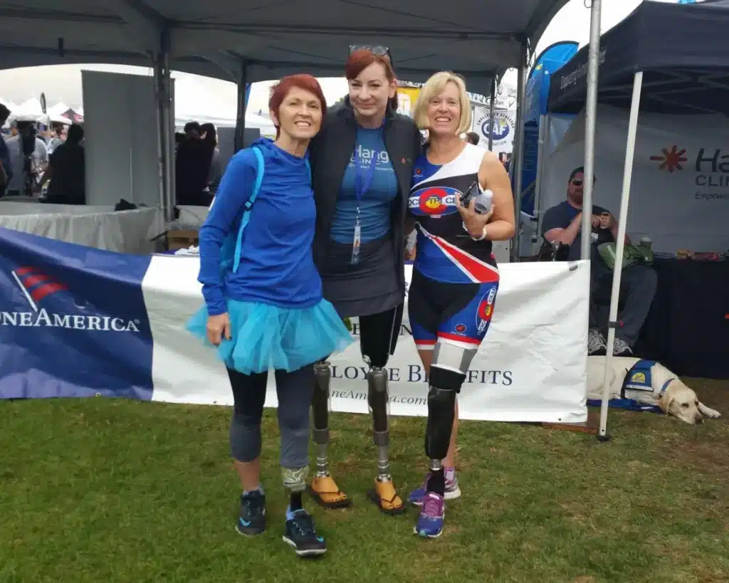 Paula Free and friends holding arms at the Challenge Athlete Foundation Triathlon in San Diego, California